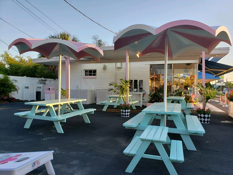 Established restaurant dining area with fixed fiberglass hard-top umbrellas over picnic tables
